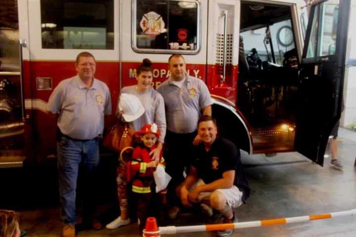 Future firefighter A.J. Kaoukakis and his mom, Liz are welcomed by Chief Bill Bahr, and assistant chiefs Bill Nikisher and Jay Kinash.