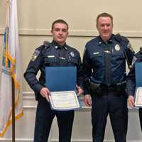 <p>Officer Cole Hinchey, Sgt. Michael Lynch and Officer Allen Troche with commendations from Mayor Paul Brodeur.</p>