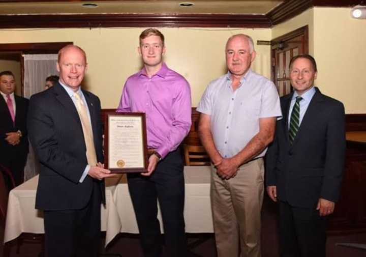 Shane Rafferty, second from left, is presented with a $1,000 scholarship.