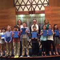 <p>The third grade class from Temple Beth El receiving their Siddur.</p>