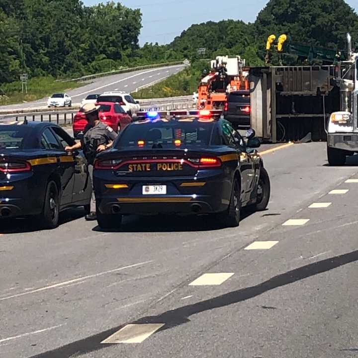 Three people were injured when a tractor-trailer flipped on I-684.