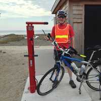 <p>Tim Bezler of Fairfield examines the town’s new stainless steel, tamperproof Bicycle Repair and Air Pump Station at Southport Beach. A second station is in place at Brookside Park near Mill Plain Road.</p>