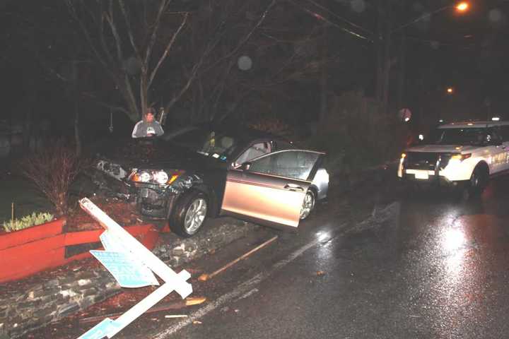 A car landed on top of a brick wall after the driver lost control of his car.