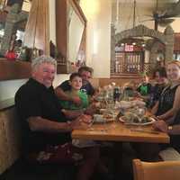 <p>The father at dinner with his family.</p>