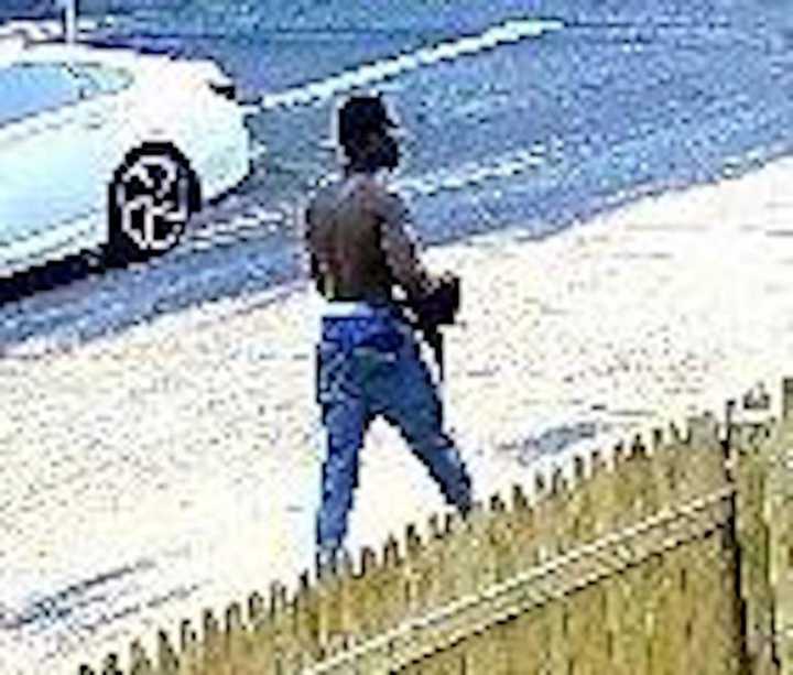 Suffolk County Police seek information on the man caught on camera for questioning in a July murder investigation.