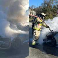 <p>Firefighters extinguishing the blaze on Route 100 Thursday morning.&nbsp;</p>