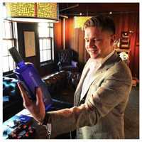 <p>CEO Adam von Gootkin admires one of the first bottles off the line of Highclere Castle Gin.</p>