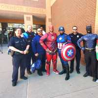 <p>Firefighters and police officers across Hampden County don superhero cowls and capes for the event at Rebecca M Johnson School on Thursday, April 14.</p>