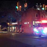 <p>Westport firefighters respond late Saturday to a blaze on the roof of a building on Post Road East at Parker Harding Plaza in the center of downtown.</p>