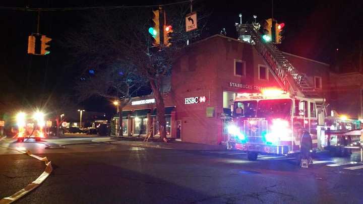 Westport firefighters respond late Saturday to a blaze on the roof of a building on Post Road East at Parker Harding Plaza in the center of downtown.