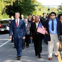 <p>Senator Terrence Murphy, Colette Carpenter and Christian Carpenter lead procession down the Major Clayton Carpenter Highway in Yorktown.</p>