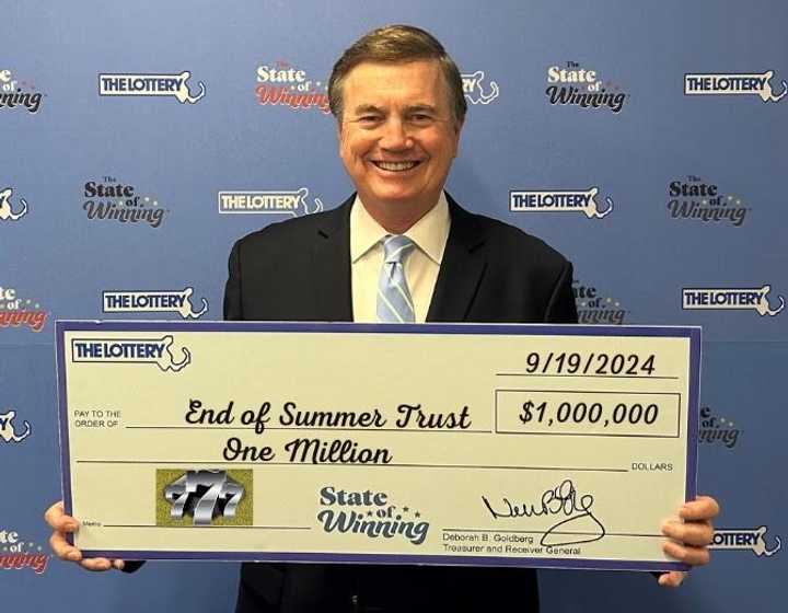 David Spillane, a representative of the End of Summer trust, with the $1 million check. 