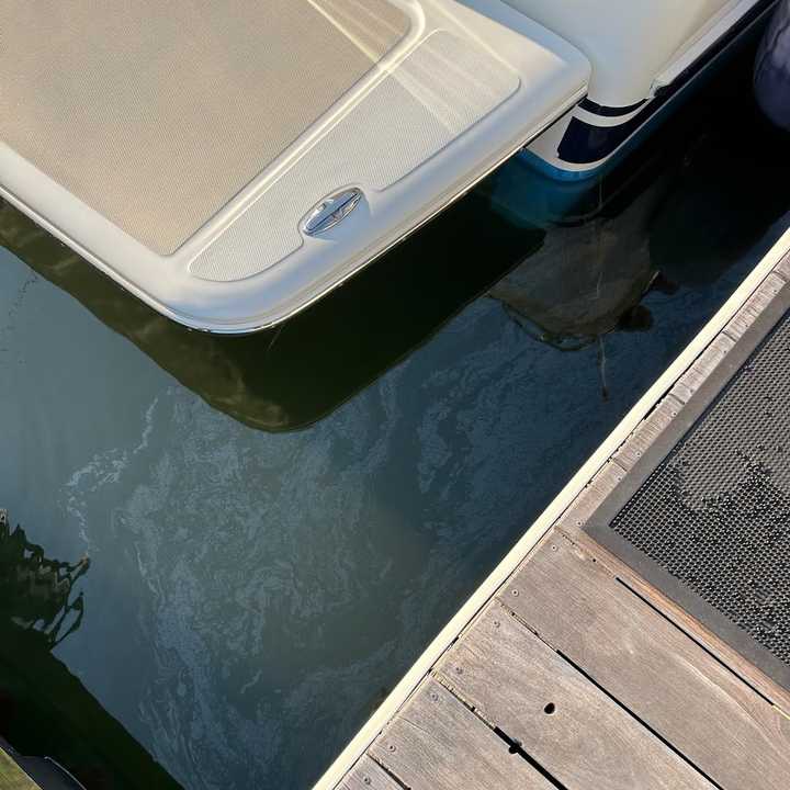 Diesel fuel shimmers on the water's surface at&nbsp;South Norwalk Boat Club after a boater dumped it from his boat along with untreated human waste, authorities said.&nbsp;