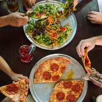 <p>Colony Grill is known for its signature "hot oil" topping, as noted on its website.</p>
