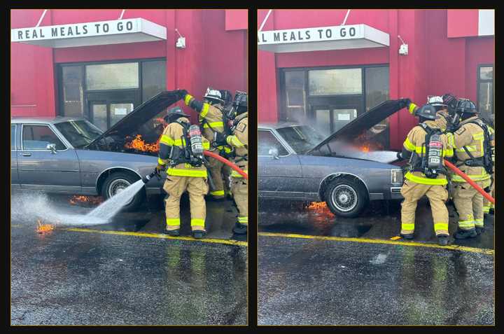 Crews knocking out the car fire at the KFC drive-thru.