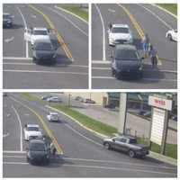 <p>The men stopping traffic to damage a vehicle at the intersection of Rowe Road and West King Street in Shippensburg.</p>