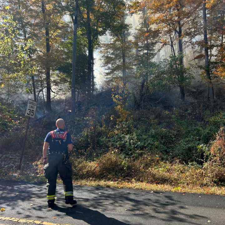 A firefighter on the scene of the brush fire on Route 32. 