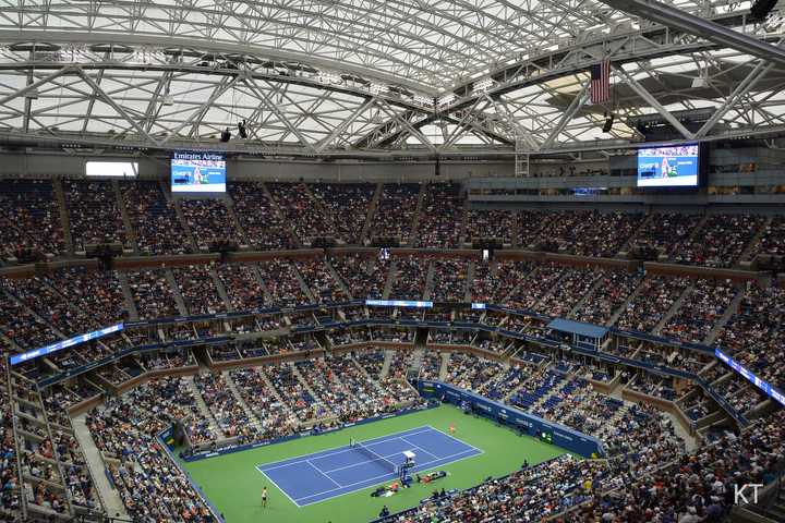 A packed Arthur Ashe Stadium with the roof closed during a marquee match at the US Open. New York’s electric tennis showcase returns in 2025 with player announcements expected August 21.Tickets are available now.