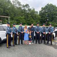 <p>Trevor and Stephanie McPherson, along with three of their five boys, are reunited with the New Jersey State Police troopers who assisted on June 2.</p>