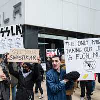 <p>Protesters outside a Tesla dealership in Chicago on March 22, 2025.</p>