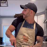 <p>Mark Longo and "Peanut" the squirrel.</p>