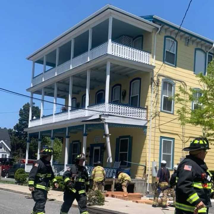 Firefighters respond to the scene of a garbage truck that crashed into a building in Cape May, NJ.