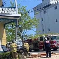 <p>Firefighters respond to the scene of a garbage truck that crashed into a building in Cape May, NJ.</p>