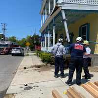 <p>Firefighters respond to the scene of a garbage truck that crashed into a building in Cape May, NJ.</p>