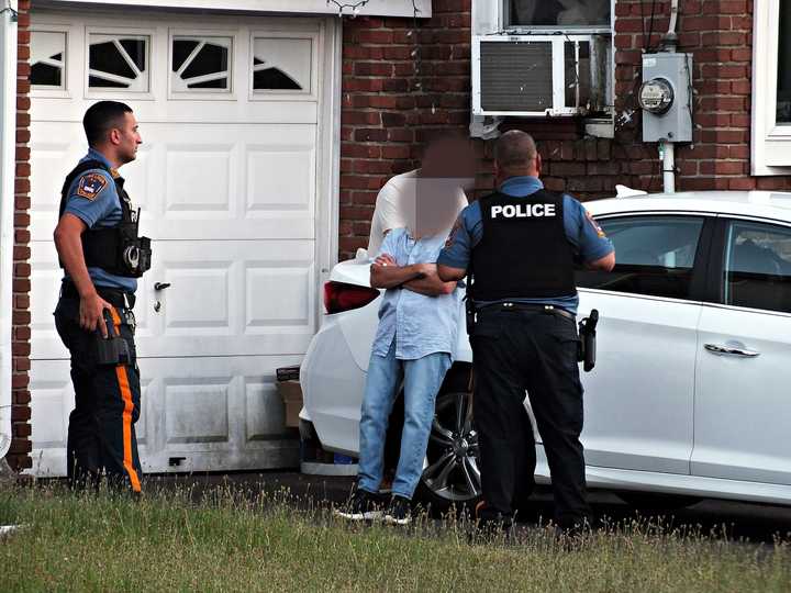 Officers speak to a suspect during the investigation in Fair Lawn.