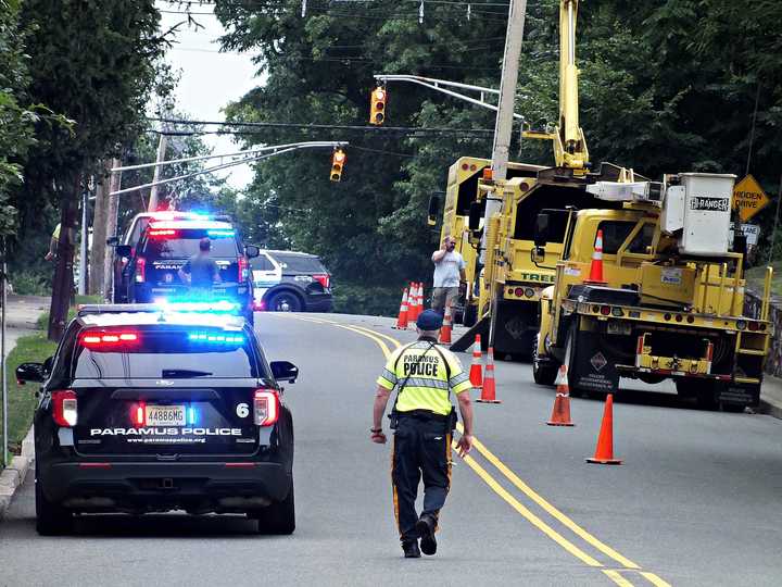 Special Police Officer Al Raimondi, in yellow, at the scene Thursday, July 25 in Paramus.