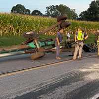 <p>Fire crews and the farm equipment that struck an SUV. </p>