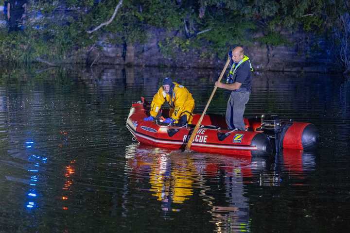 Vernon dive team members searching for the man spotted swimming across the pond.&nbsp;&nbsp;