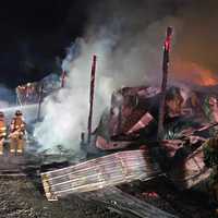 <p>Firefighters battling a barn fire.</p>