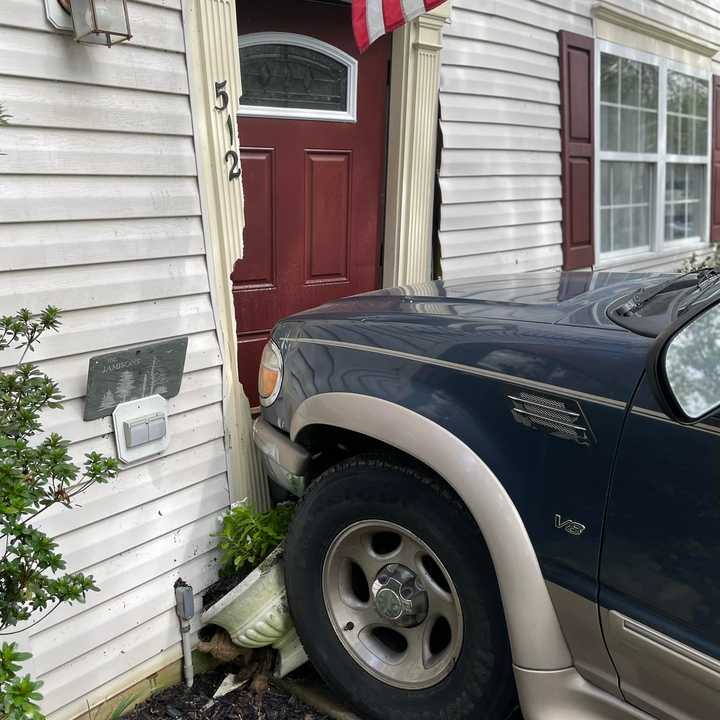 The delivery driver reportedly failed to put the car into park before crashing into the home.