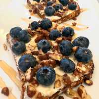 <p>Honey pecan almond toast with blueberries.</p>