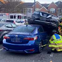 SUV Goes Airborne, Lands On Parked Sedan In Fair Lawn Mishap