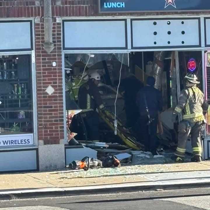 Firefighters work to clear the scene after a car drove through the front of Rosa Vega Bakery De Puerto Rico on Main Street in Torrington on Friday, Dec. 13, just before noon.  