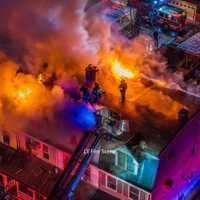 <p>Firefighters on the scene of the rowhome blaze</p>