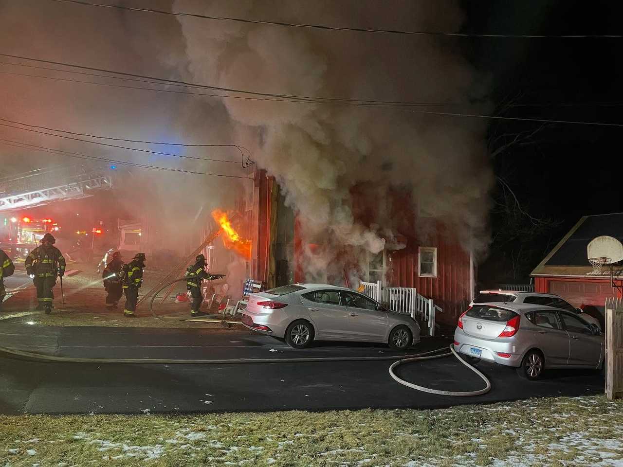 Southington firefighters battle an early morning blaze on Howard Avenue on Thursday, Dec. 26.  