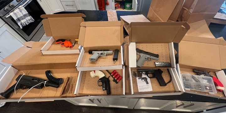 An image of some of the weapons found during a search at the duo's residence, according to police. 