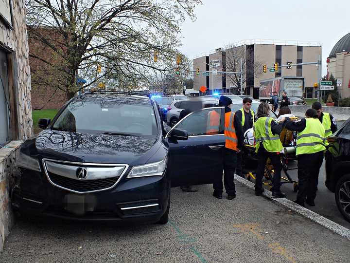 A dark blue Acura SUV slammed into a building in Fair Lawn on Saturday morning, April 5, sending the driver to the hospital and leaving behind a trail of damage, authorities said.