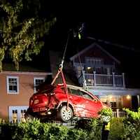 Car Crashes Into Yard In Rockland, Lifted Out Using Rotator