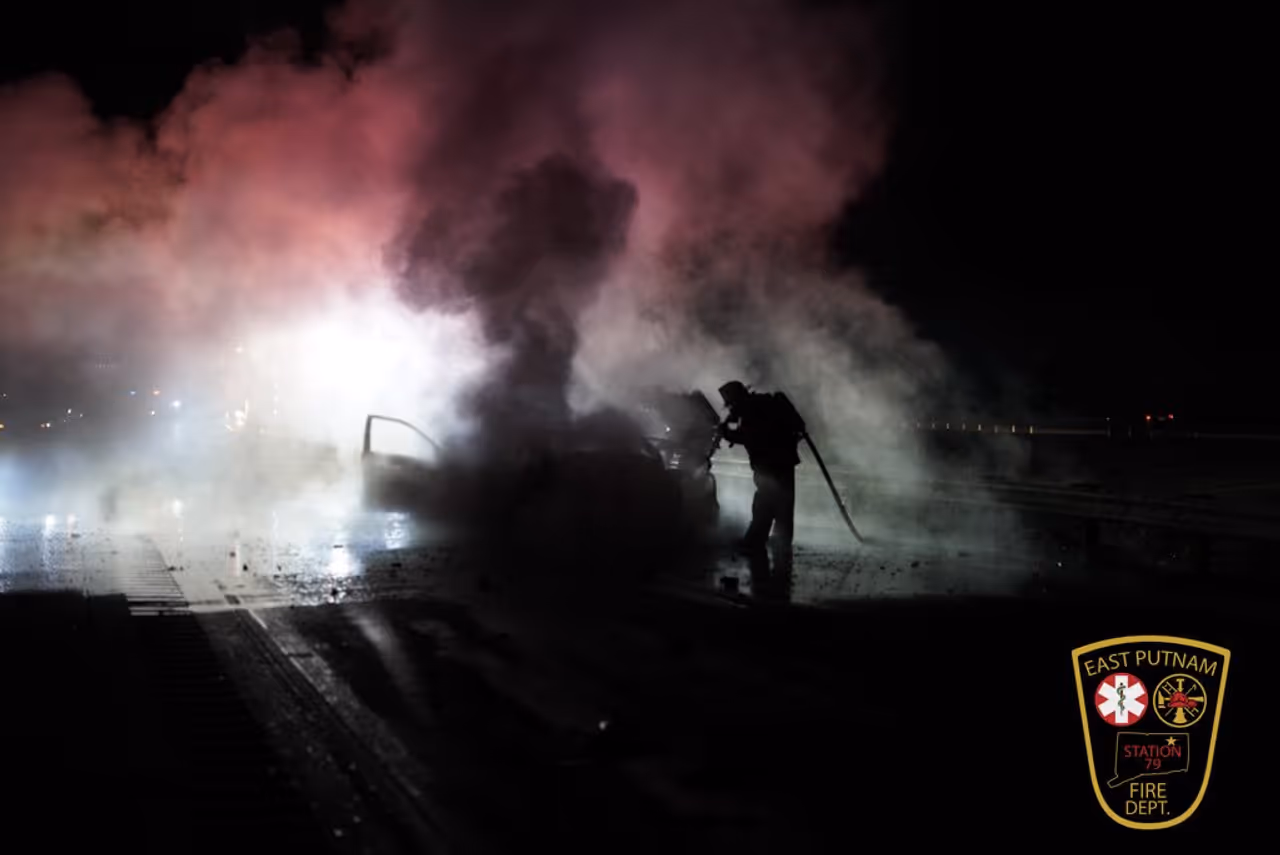 Firefighters extinguish a vehicle fire after a crash between a car and a tractor-trailer on I-395 in East Putnam near the Killingly line Wednesday morning, Nov. 19. Firefighters extinguish a vehicle fire after a crash between a car and a tractor-trailer on I-395 in East Putnam near the Killingly line Wednesday morning, Nov. 19. 