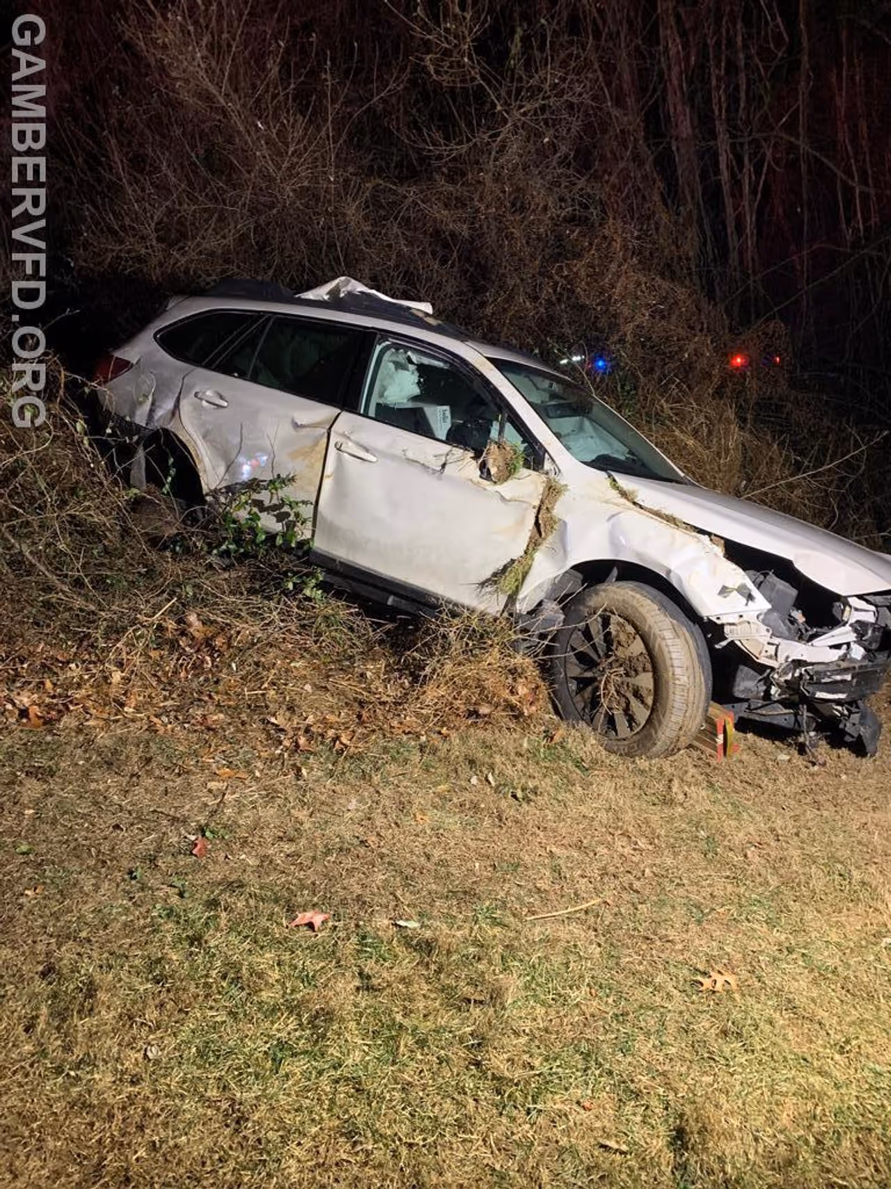 The vehicle had run off the road, over a guardrail, and down a slope The vehicle had run off the road, over a guardrail, and down a slope