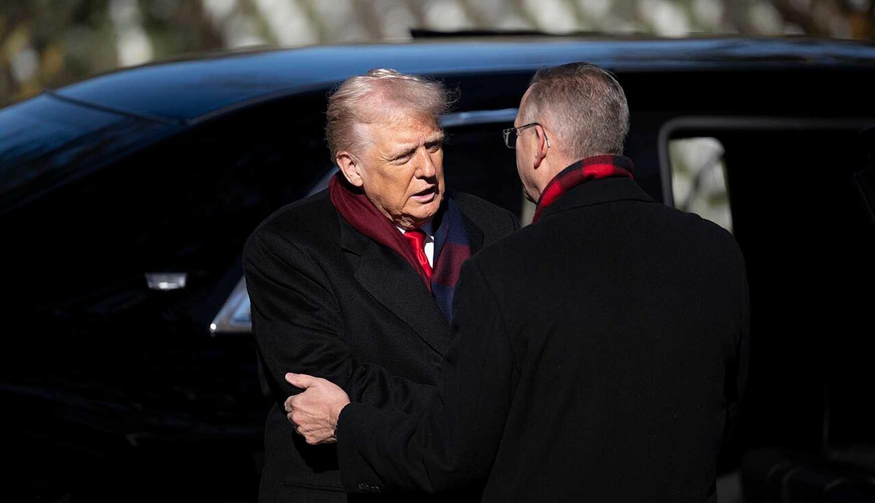 
President Donald Trump shakes hands with Secretary of Veterans Affairs Doug Collins before a ceremony at Arlington National Cemetery on November 11, 2025.
