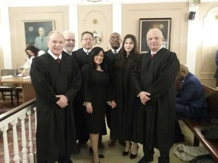 Peekskill City Court Judge Lissette Fernandez (center) has filed a lawsuit against the City of Peekskill, claiming that she was retaliated against for speaking out against former judge Reginald Johnson (back row, third from right).