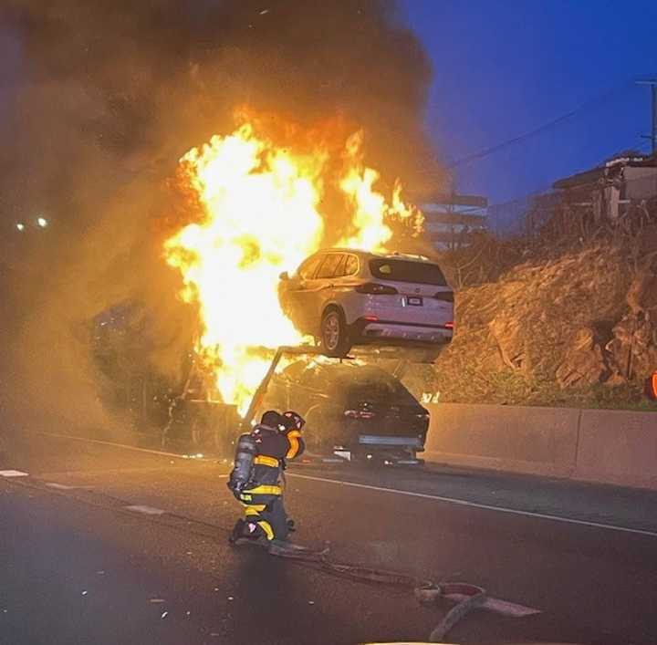 Norwalk firefighters battle a car-carrier truck blaze on I-95 Wednesday morning, April 9.&nbsp;