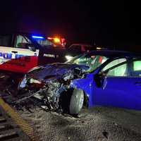 <p>A car crashed into a parked Plainfield police car as the officer managed traffic so firefighters could put out a car carrier fire Saturday morning, April 26.&nbsp;</p>