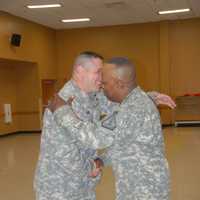 <p>US Army Sergeant Major Eric R. Hunt embracing Master Sergeant Ishmoile Mohammed during Hunt's promotion in 2014.</p>