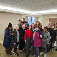<p>"FBI: Most Wanted" star Keisha Castle-Hughes (in red) with a group of staff and residents from Wartburg.</p>